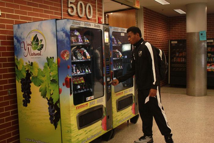 Student decides on the $1.25 fruit snacks during his 6th period class. The vending machines have been updated to include healthy snacks.