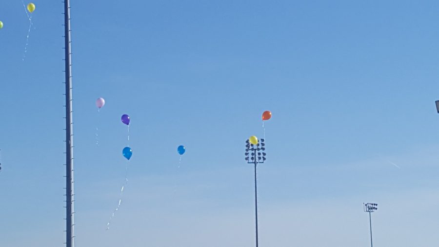 All teachers and students of the Special Education had to write how they feel on a balloon and they released them up to the sky because one of there teachers got in a car accident. 