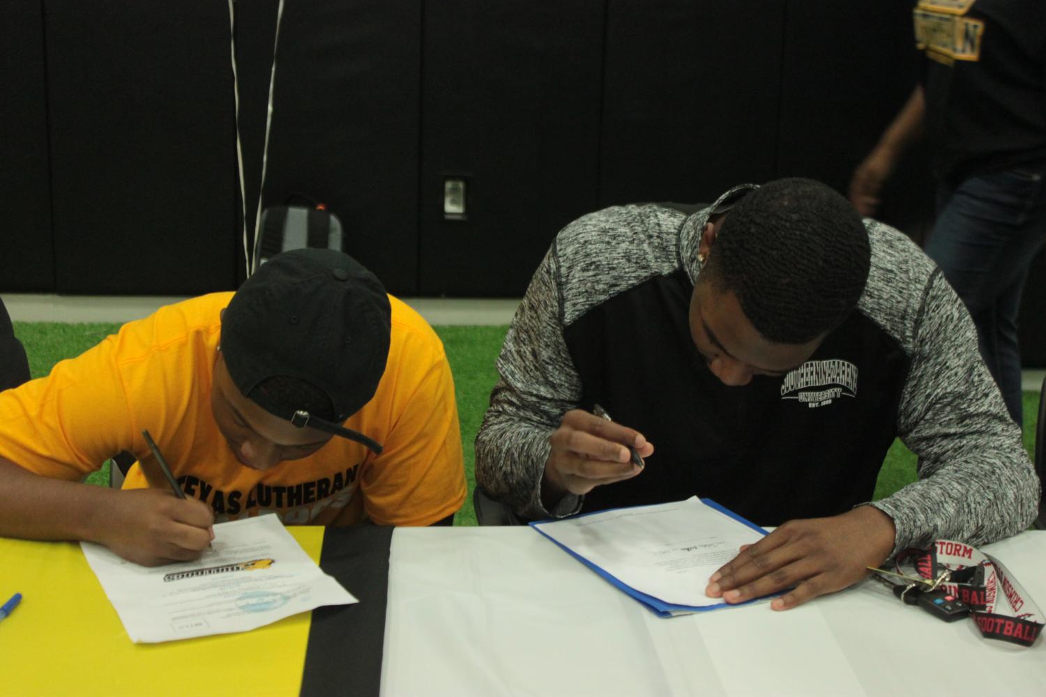 Khari+Clarkson+and+Nick+Caruthers+both+signed+their+scholarship+to+Texas+Lutheran+University.